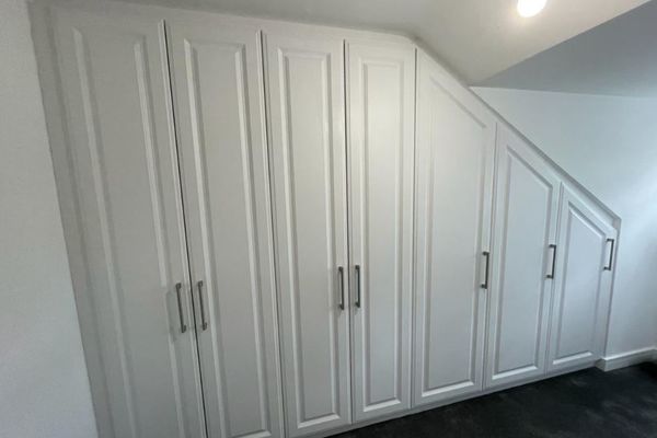 Fitted angled wardrobes in Satin white