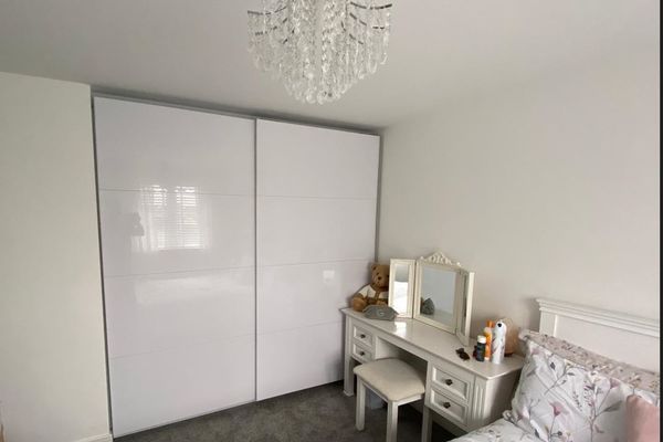 Sliding gloss white fitted wardrobes